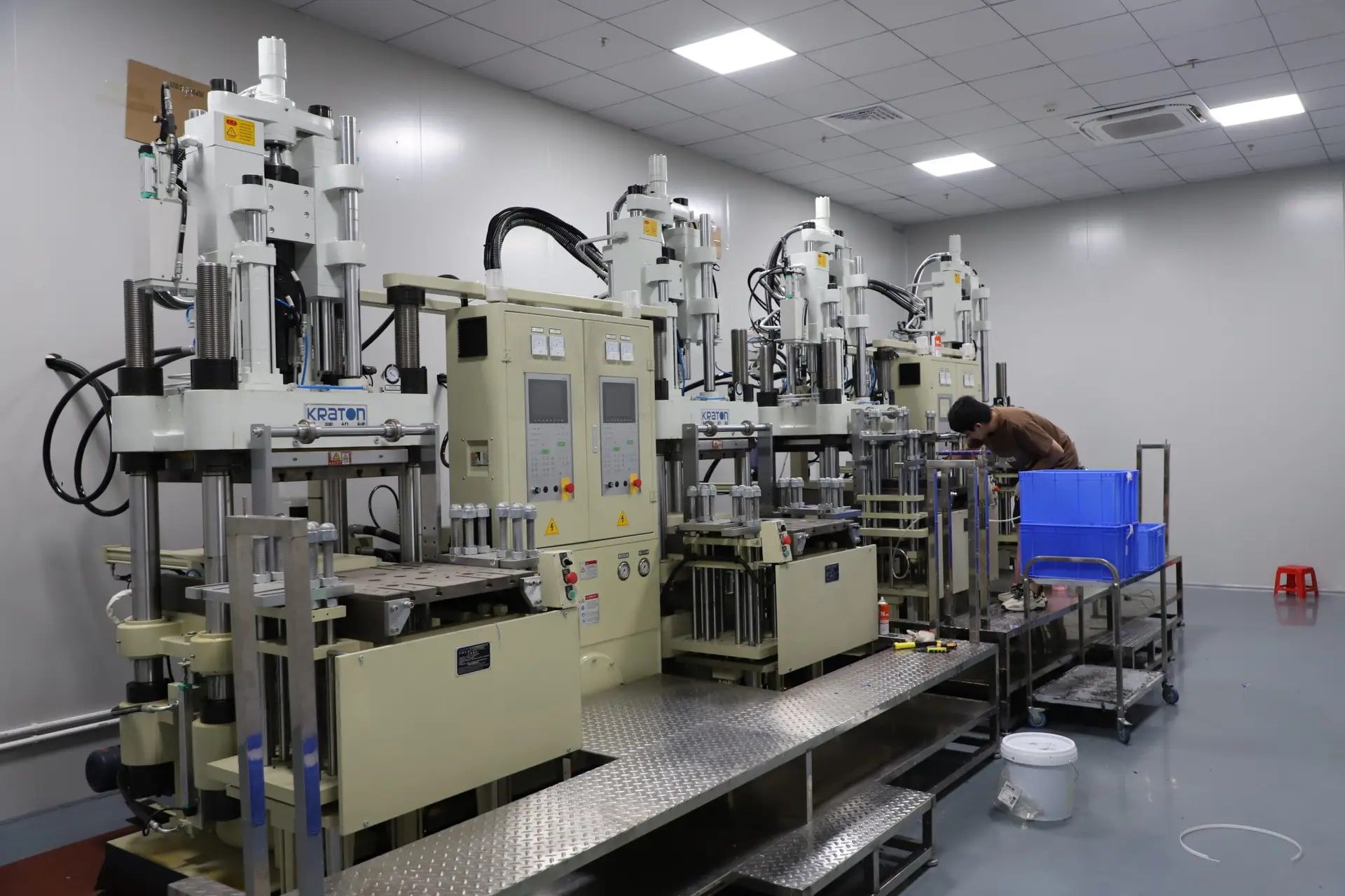 Row of 4 vertical LSR injection molding machines on Leutoo's molding floor in Dongguan