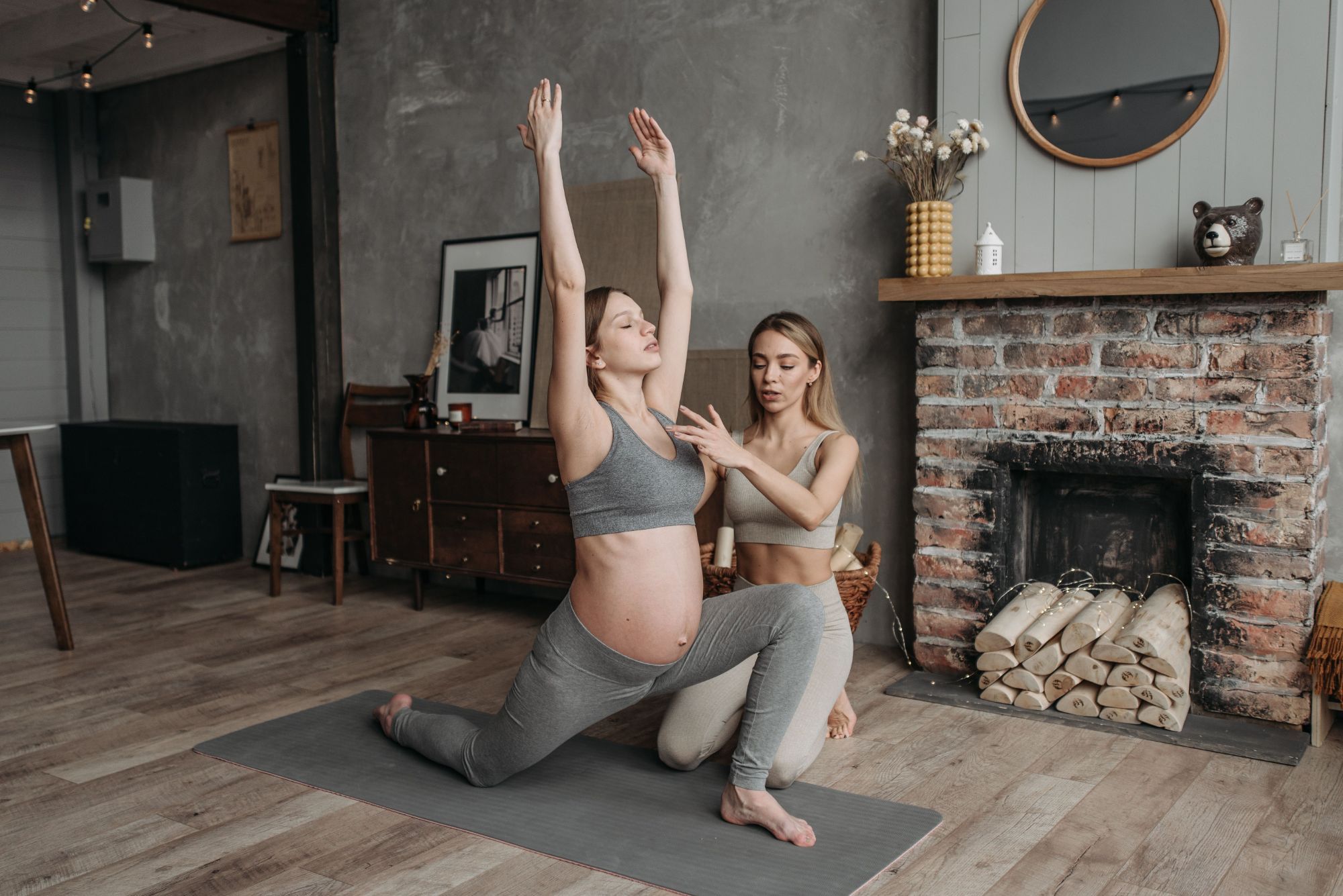 Pregnant woman doing a guided stretching and pelvic floor exercise with an instructor at home