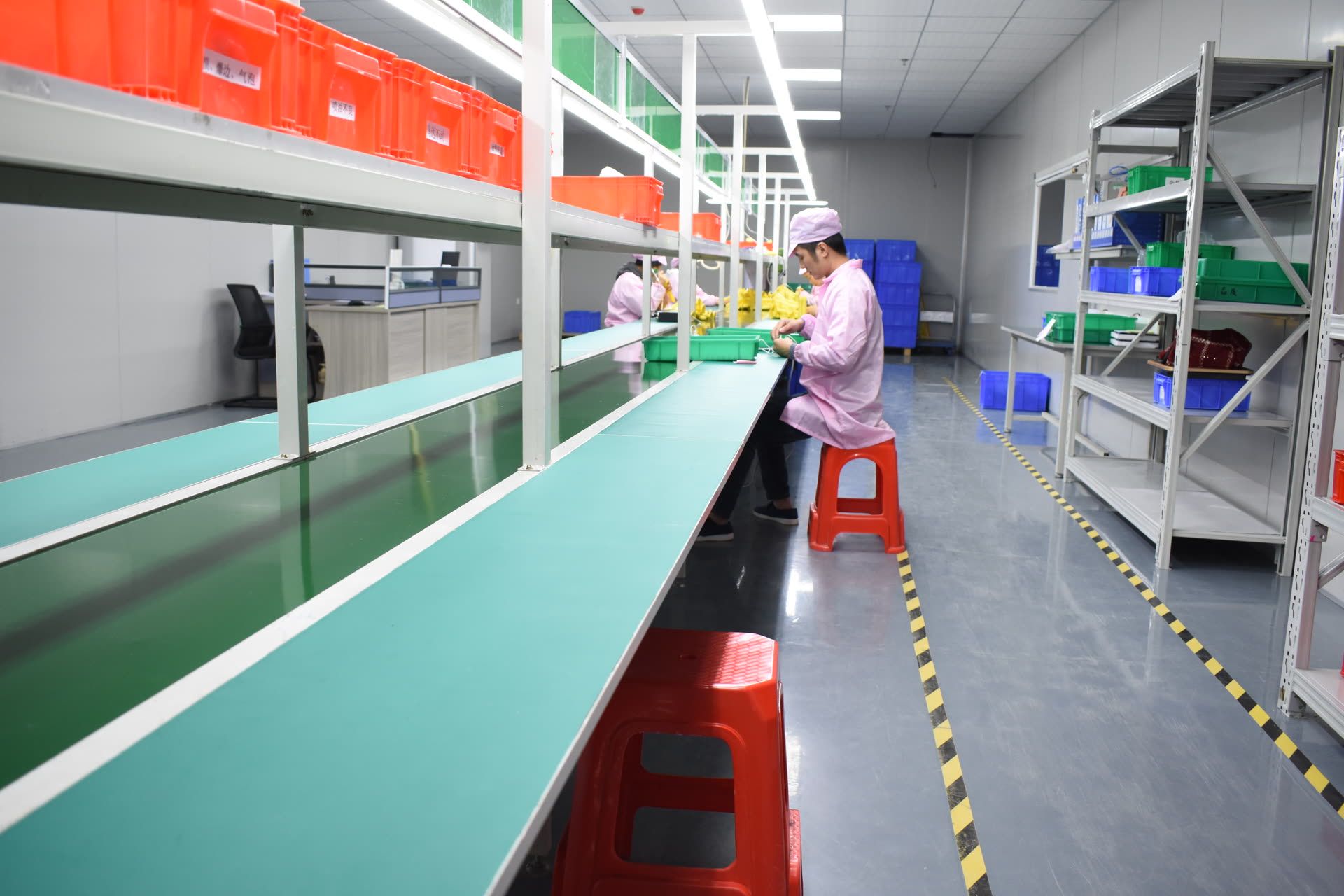 Inspection line with operators in cleanroom gowns